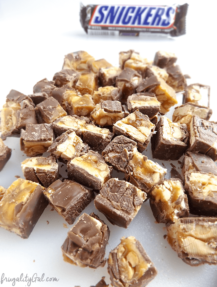 Chopped snickers bars on a cutting board.