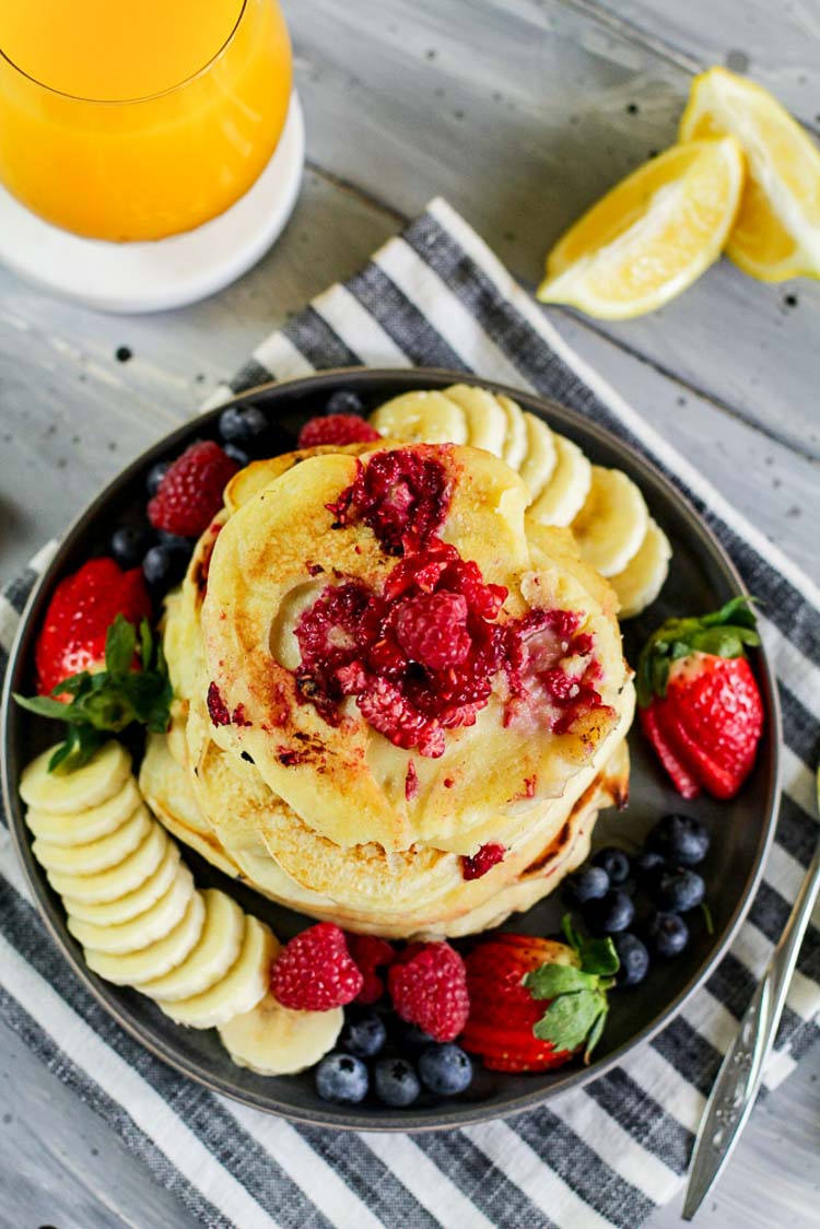 Top Down view of the pancakes with blueberries, raspberries, strawberries and bananas