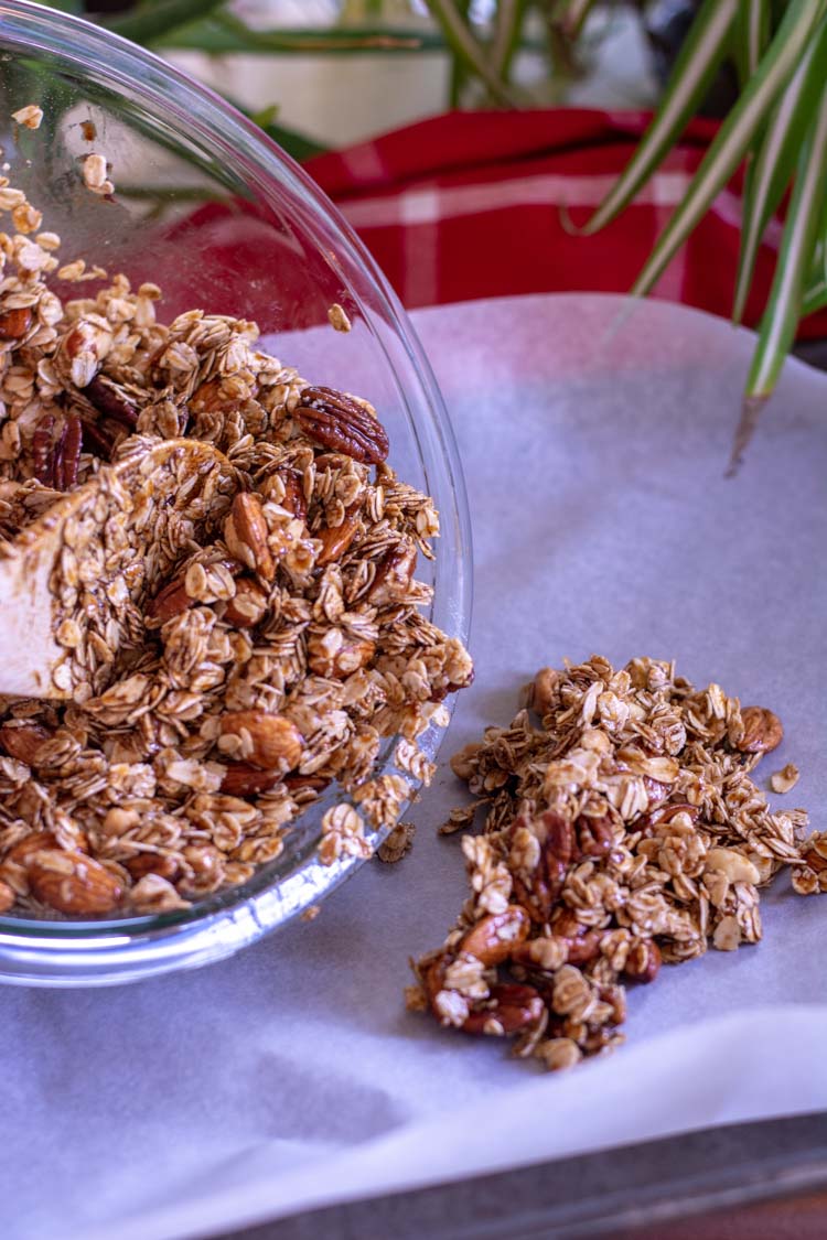 Pouring the Granola on the sheet pan and ready for the oven.