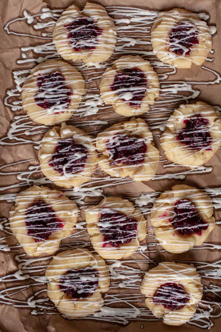 Cranberry Bliss Cookies on a sheet pan with white chocolate stripes.