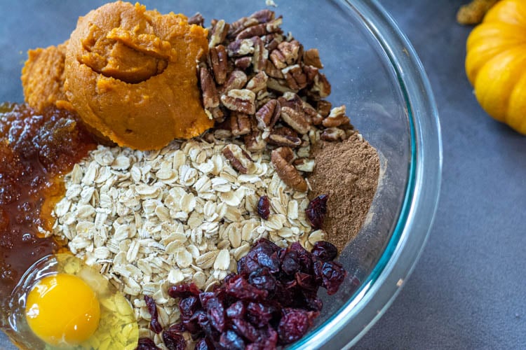 Glass bowl with the ingredients for the pumpkin oatmeal breakfast cookies.