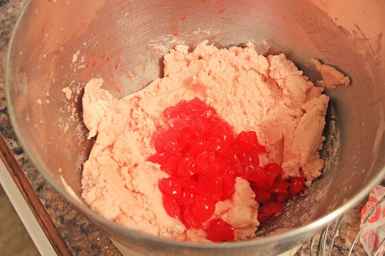 mixing bowl with batter and cherries ready for mixing.