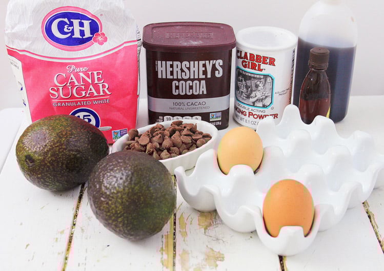 Ingredients for the gluten-free chocolate avocado brownies on a white board.