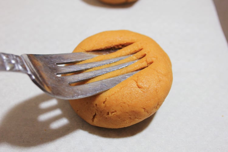 Pressing the sunflower seed cookie dough with a fork.
