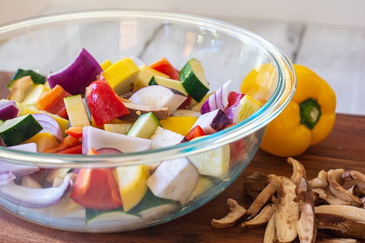 Glass Bowl filled with chopped mixed vegetables ready to be roasted.