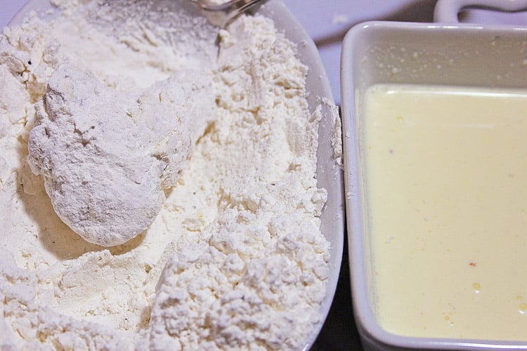 one bowl with the egg mixture and one bowl with the flour mixture to coat a chicken wing.