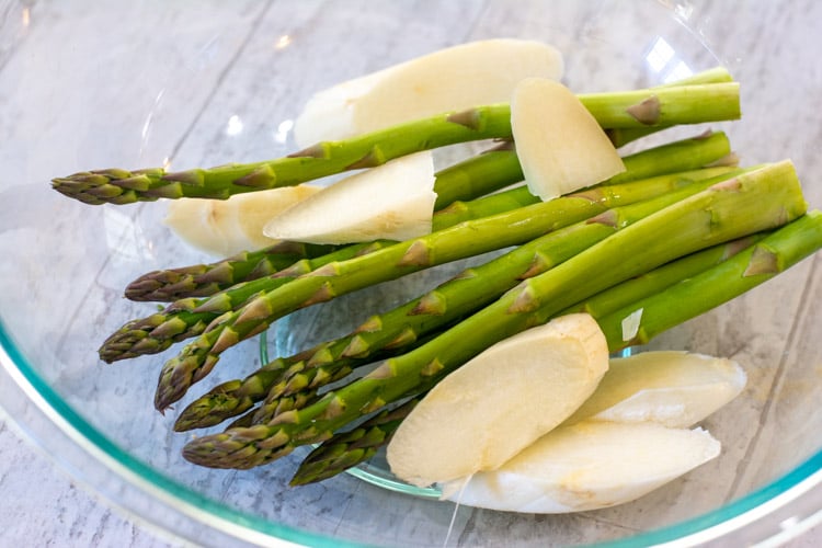 glass bowl with white and green asparagus.