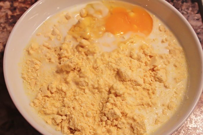 adding egg and milk to the corn meal mixture.