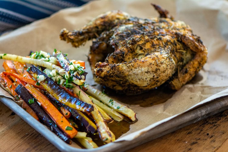 cornish hen on a small sheet pan with air fried carrots.