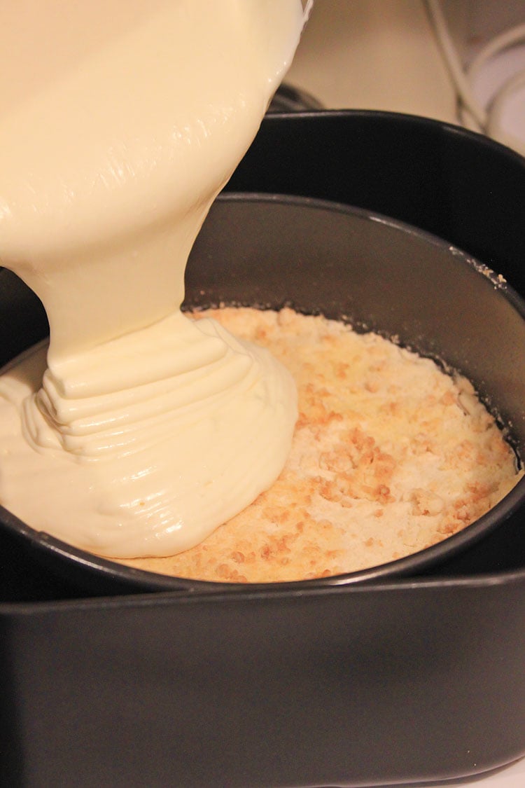 pouring the batter on top of the cookie crust.