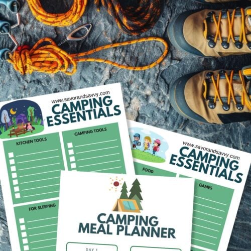 Free printable camping checklists and meal planner on a rugged surface next to hiking boots and gear.