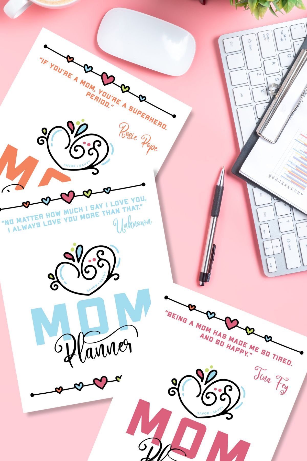 Three printable covers for the mom planner on a pink table next to a laptop.