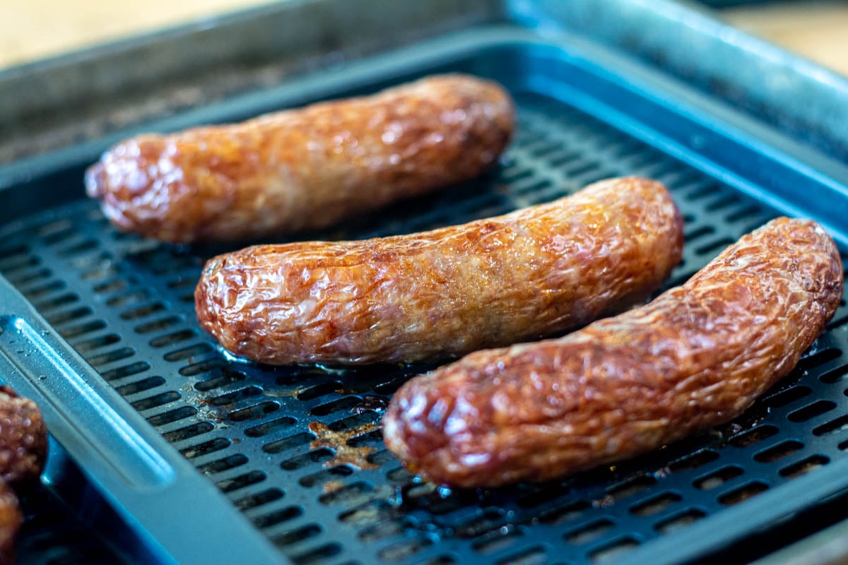 tray with the fully cooked beer brats on them straight out of the air fryer.