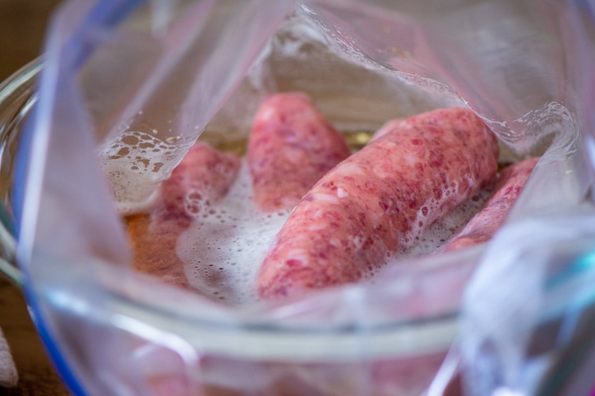 marinating the bratwurst in beer in a Ziploc bag.