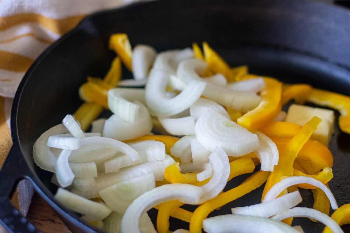 sautéing the onions and peppers in a cast iron skillet.