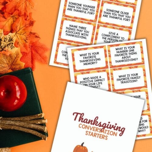 Top view of free printable Thanksgiving conversation starters on an orange background next to autumn decor.