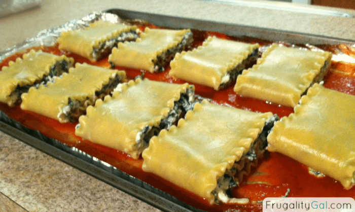 folding over the pasta noodles to form the roll up.