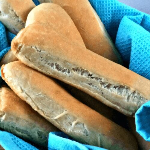 Close-up of freshly baked breadsticks in a basket.
