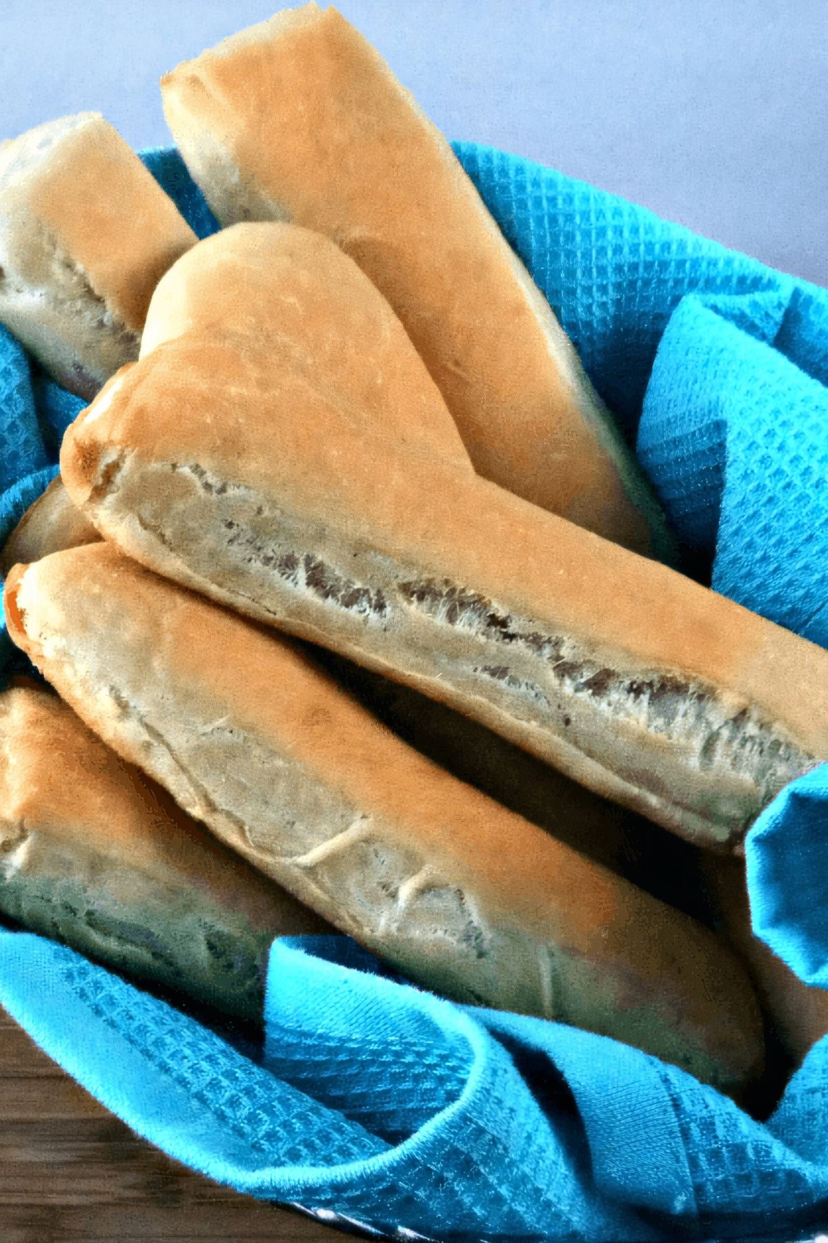 Close-up of freshly baked breadsticks in a basket.