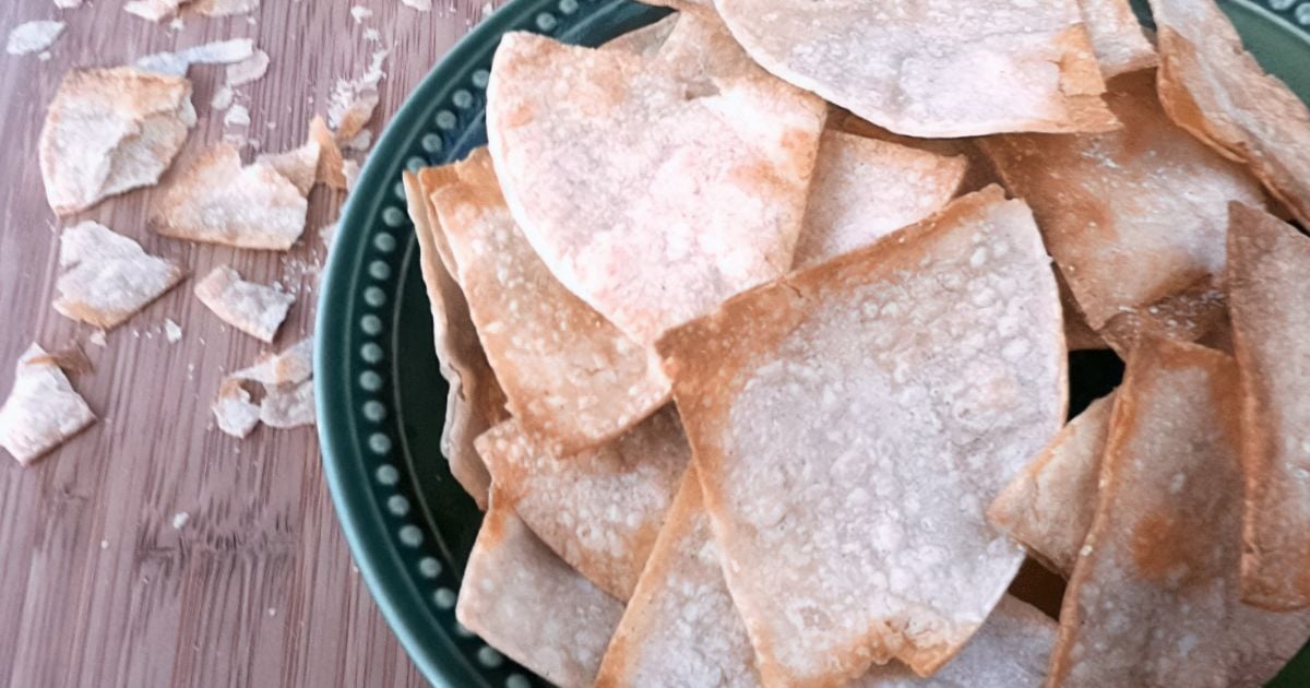 Crispy and golden homemade tortilla chips on a bowl.