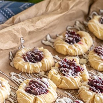 sheet pan with thumbprint cookies coving is icing.