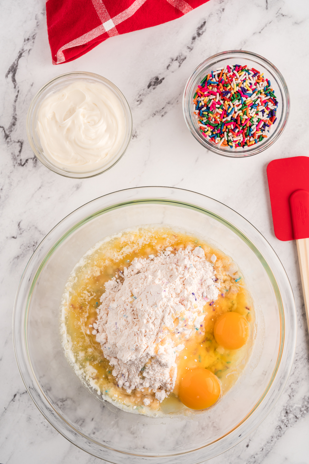 All the ingredients for funfetti cake box cookies in a bowl.