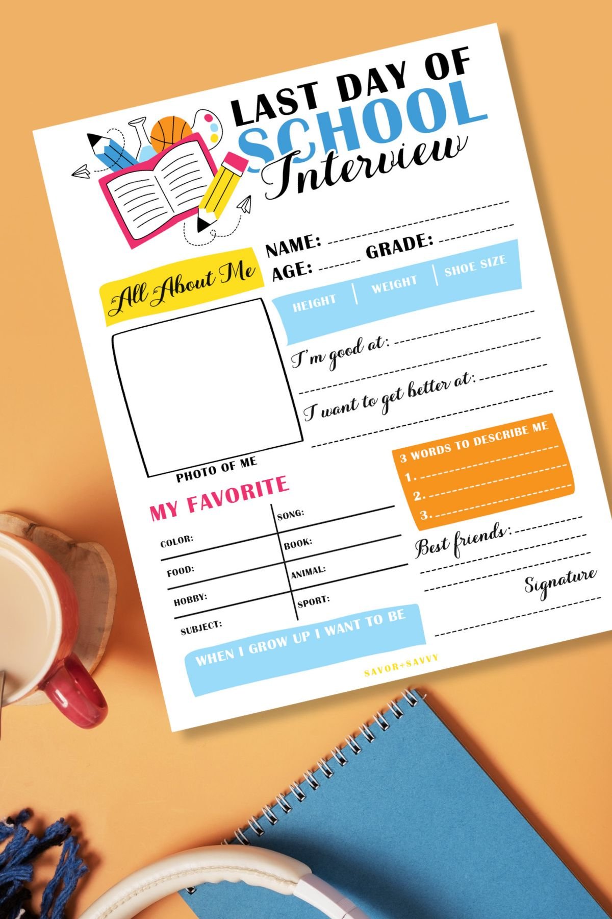 Top view of free printable last day of school questionnaire on orange background next to cocoa cup and notepad.