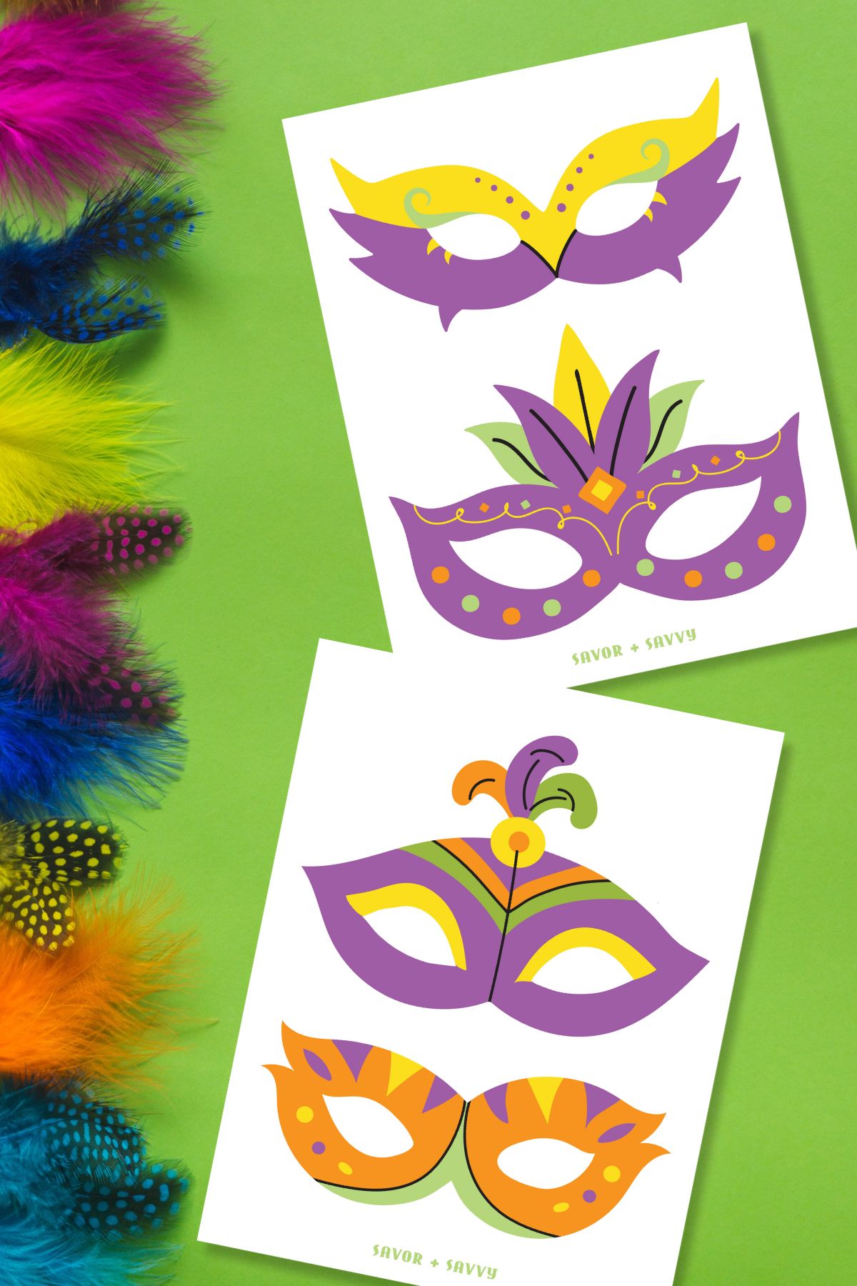 Top view of free printable Mardi Gras mask templates for kids on green background with feathers.