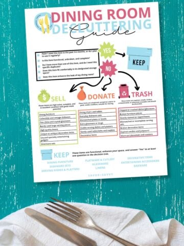 Free printable decluttering guide for the dining room on a blue surface next to cutlery.