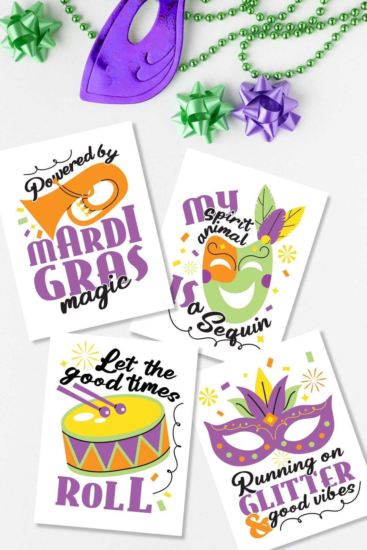 Flat lay with free printable Mardi Gras signs next to beads and masks.