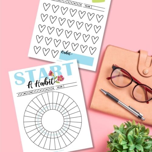 Start A Habit free printable trackers on a pink desk next to laptop and glasses.