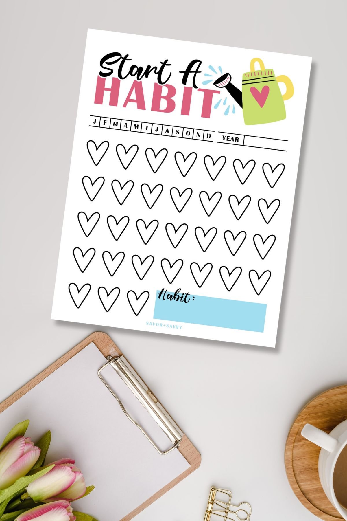 Top view of hearts themed habit tracker printable for new habits.