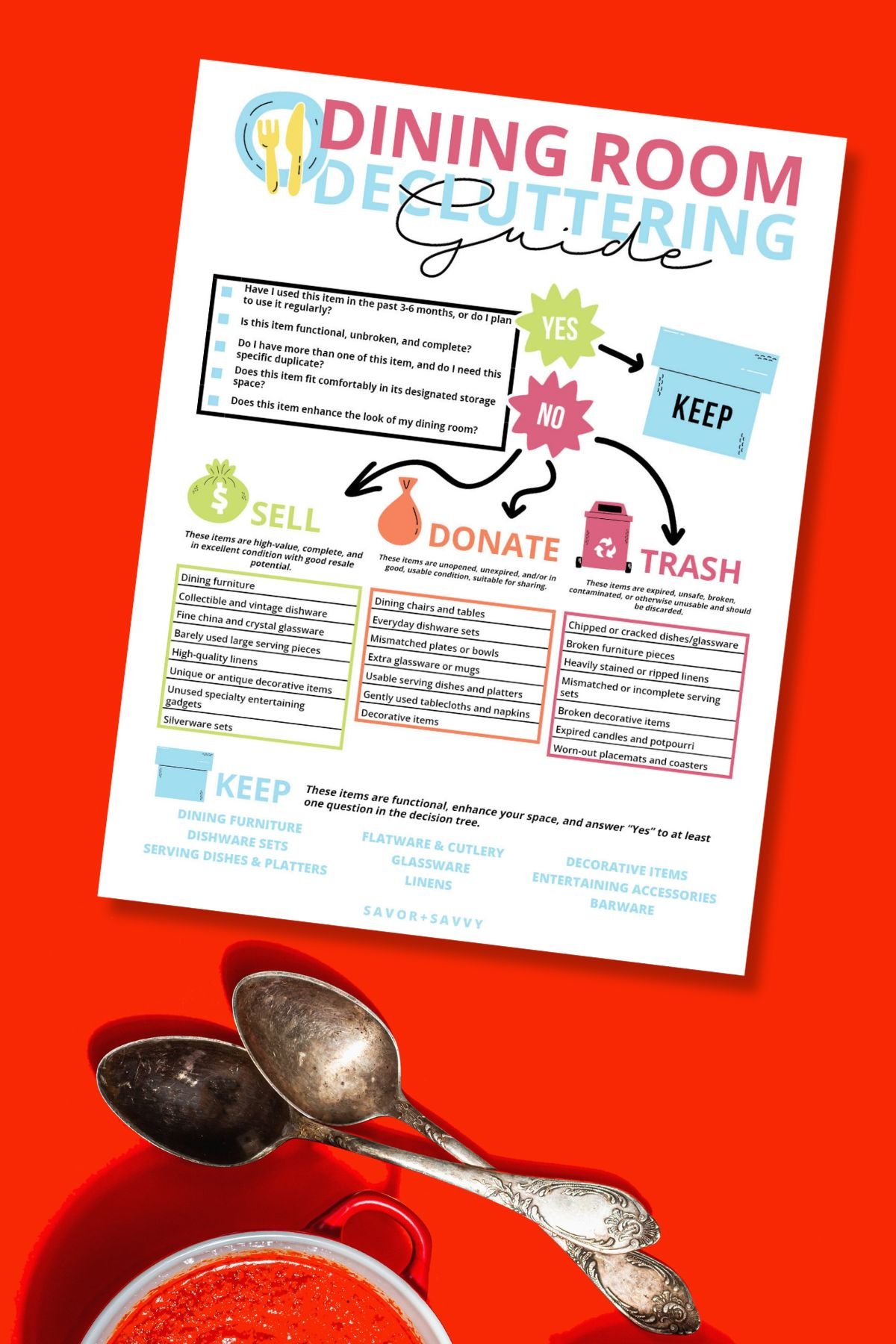 Top view of free printable dining room decluttering guide on a red surface next to two spoons.