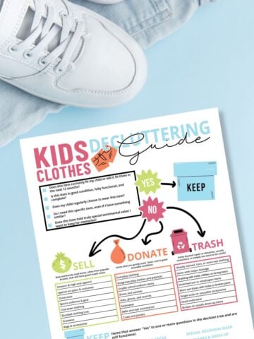 Free printable kids clothes decluttering guide on blue background next to sneakers and blue jeans.