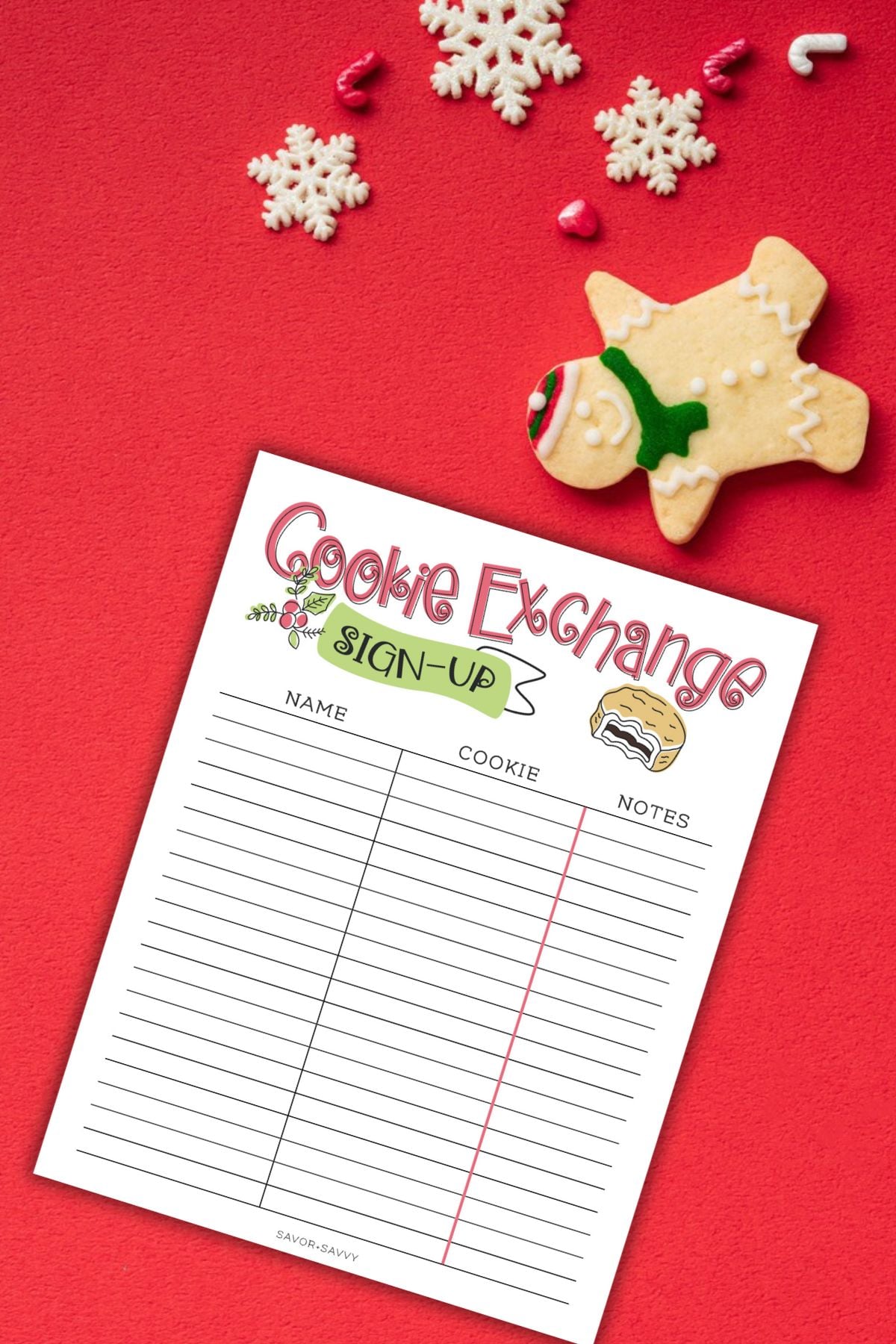 Free printable Christmas cookie exchange sign-up sheet on a red table next to gingerbread cookie.