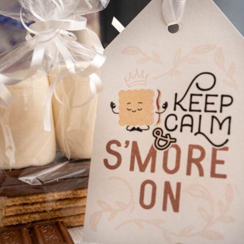 "Keep calm and S'more on" printable gift tag with a S'more gift kit in the background.