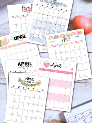 several calendar pages of the free printable April 2027 calendar on a desktop with a keyboard.