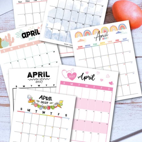 several calendar pages of the free printable April 2027 calendar on a desktop with a keyboard.